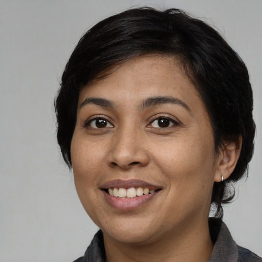 Joyful asian young-adult female with medium  black hair and brown eyes