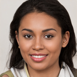 Joyful latino young-adult female with medium  brown hair and brown eyes