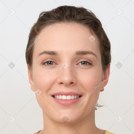 Joyful white young-adult female with short  brown hair and grey eyes