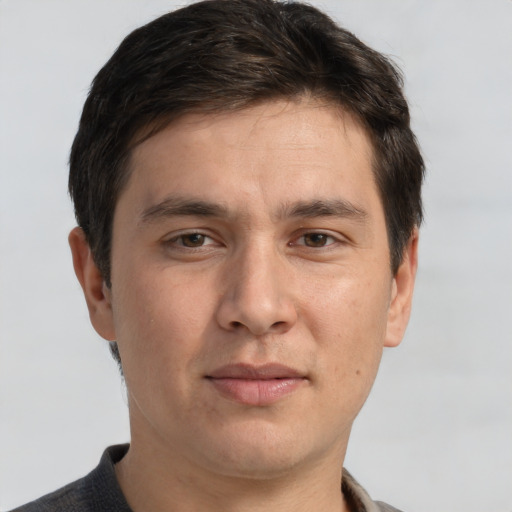 Joyful white adult male with short  brown hair and grey eyes