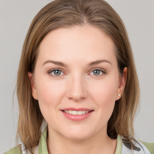 Joyful white young-adult female with medium  brown hair and grey eyes