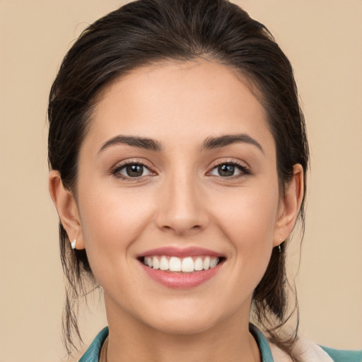 Joyful white young-adult female with medium  brown hair and brown eyes