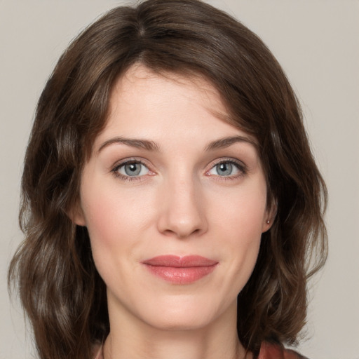 Joyful white young-adult female with medium  brown hair and green eyes