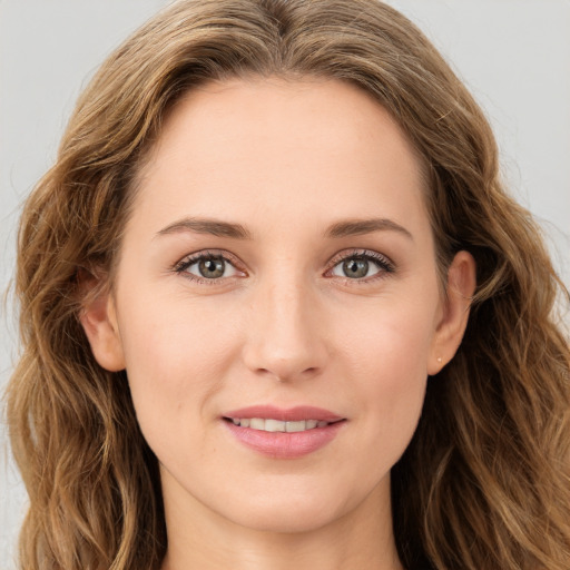 Joyful white young-adult female with long  brown hair and green eyes