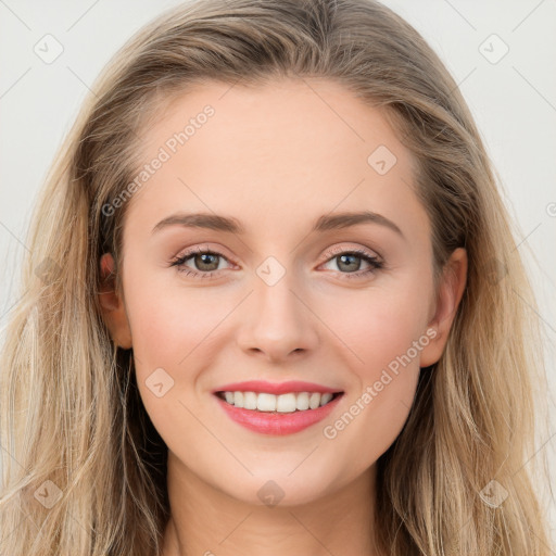 Joyful white young-adult female with long  brown hair and blue eyes