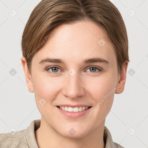 Joyful white young-adult female with short  brown hair and grey eyes