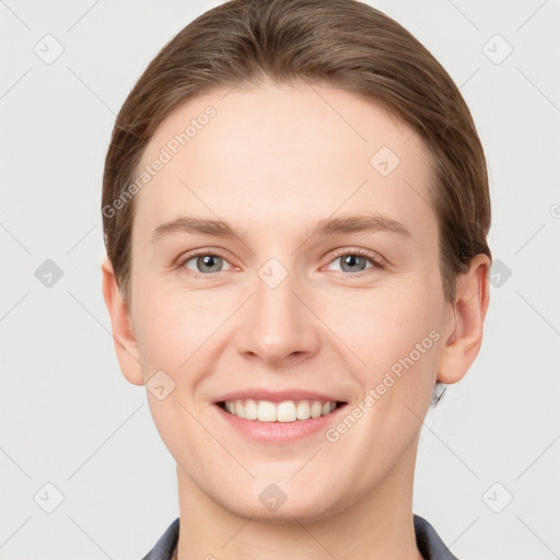 Joyful white young-adult female with short  brown hair and grey eyes