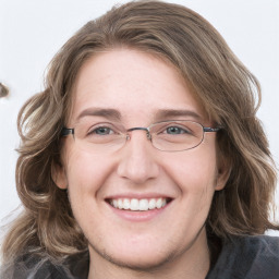 Joyful white young-adult female with long  brown hair and blue eyes