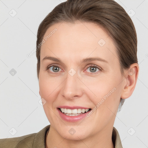 Joyful white adult female with short  brown hair and grey eyes