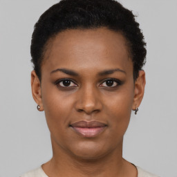 Joyful black young-adult female with short  brown hair and brown eyes