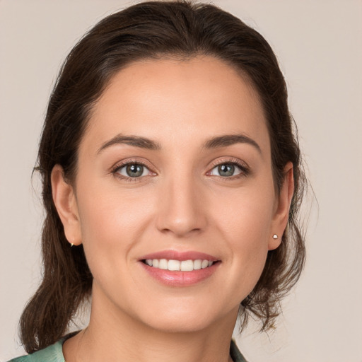 Joyful white young-adult female with medium  brown hair and brown eyes