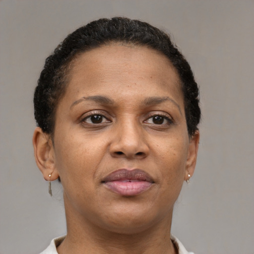 Joyful black young-adult female with short  brown hair and brown eyes