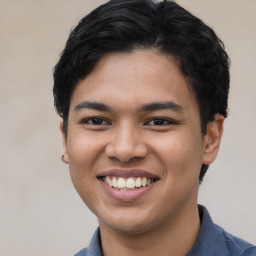 Joyful latino young-adult male with short  brown hair and brown eyes