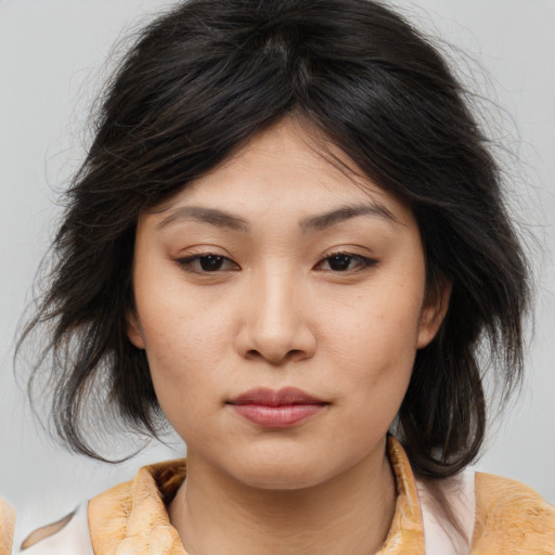 Joyful asian young-adult female with medium  brown hair and brown eyes