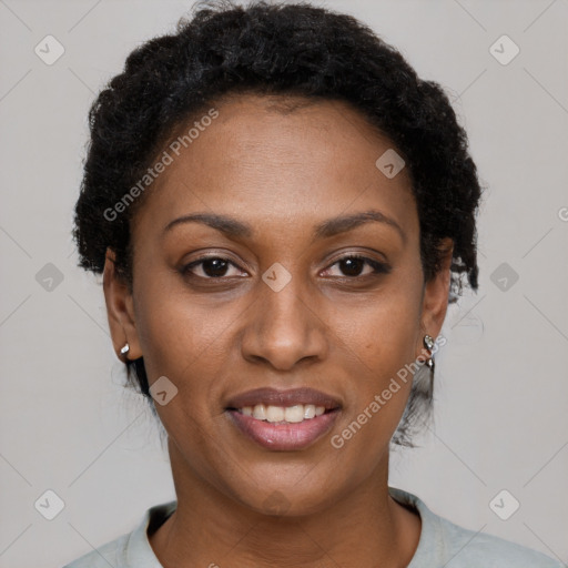 Joyful black adult female with short  brown hair and brown eyes