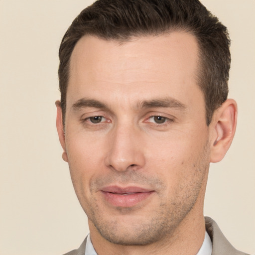 Joyful white young-adult male with short  brown hair and brown eyes