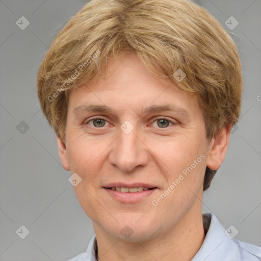 Joyful white adult male with short  brown hair and grey eyes