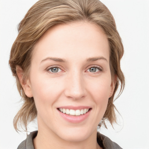 Joyful white young-adult female with medium  brown hair and blue eyes