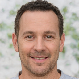 Joyful white adult male with short  brown hair and brown eyes