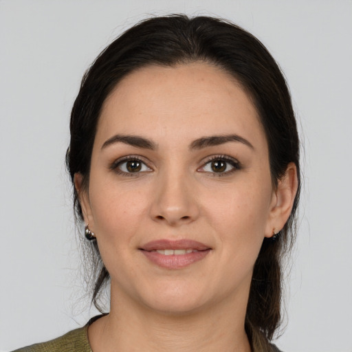 Joyful white young-adult female with medium  brown hair and brown eyes