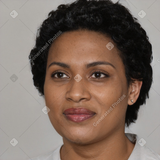 Joyful black young-adult female with short  black hair and brown eyes