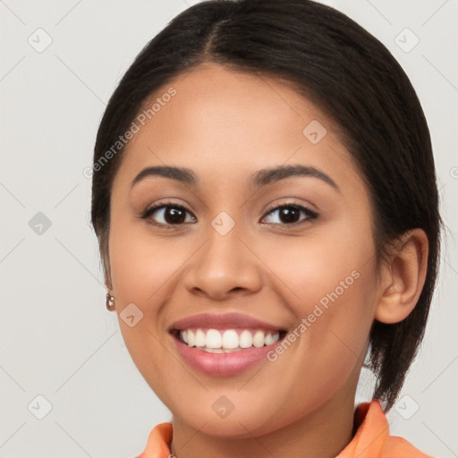 Joyful latino young-adult female with long  brown hair and brown eyes