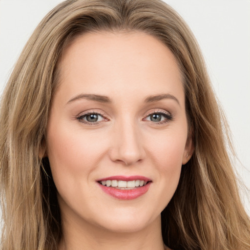 Joyful white young-adult female with long  brown hair and green eyes