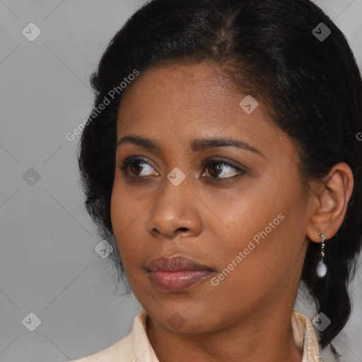 Joyful black young-adult female with medium  brown hair and brown eyes