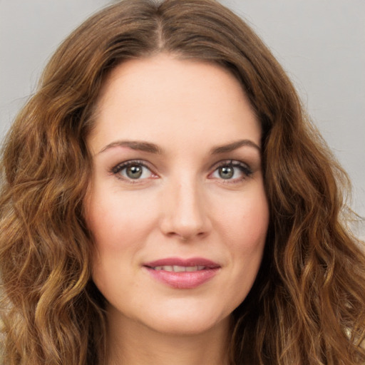 Joyful white young-adult female with long  brown hair and green eyes