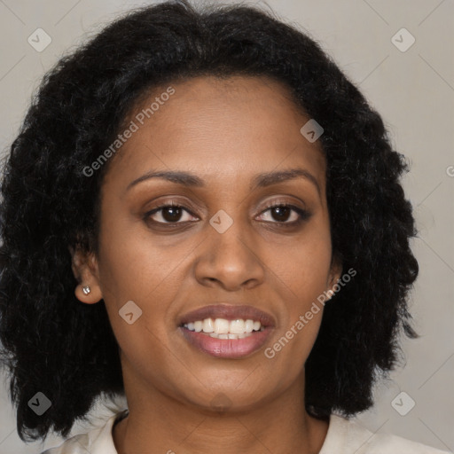 Joyful black young-adult female with long  brown hair and brown eyes