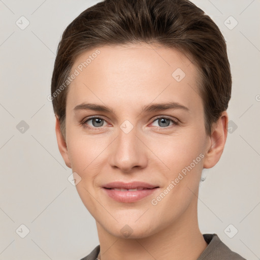 Joyful white young-adult female with short  brown hair and grey eyes