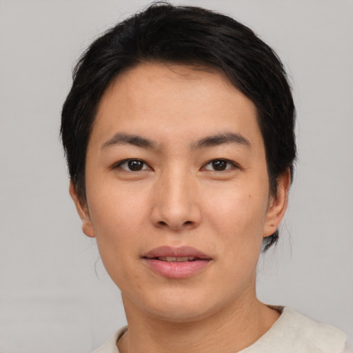Joyful asian young-adult female with short  black hair and brown eyes