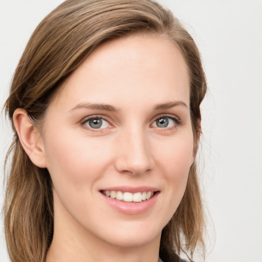 Joyful white young-adult female with long  brown hair and blue eyes