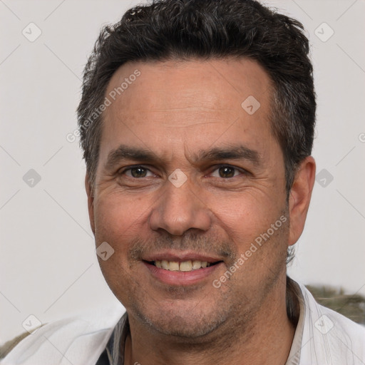 Joyful white adult male with short  black hair and brown eyes