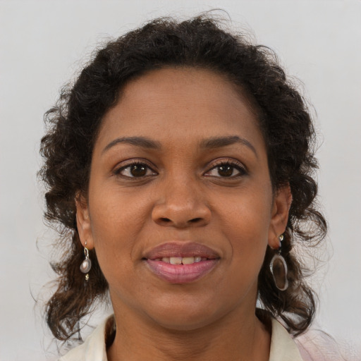 Joyful black young-adult female with medium  brown hair and brown eyes