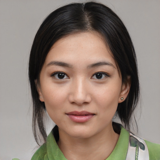 Joyful white young-adult female with medium  black hair and brown eyes