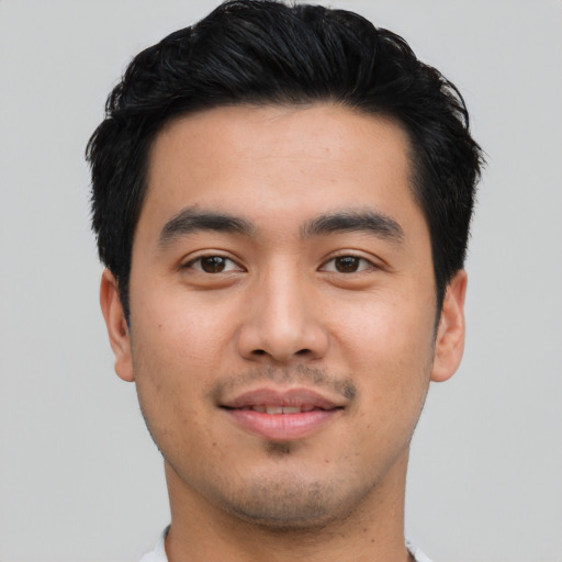 Joyful asian young-adult male with short  black hair and brown eyes