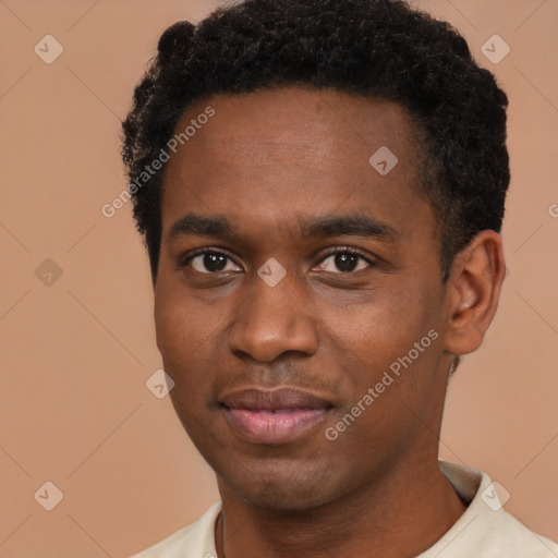 Joyful black young-adult male with short  brown hair and brown eyes
