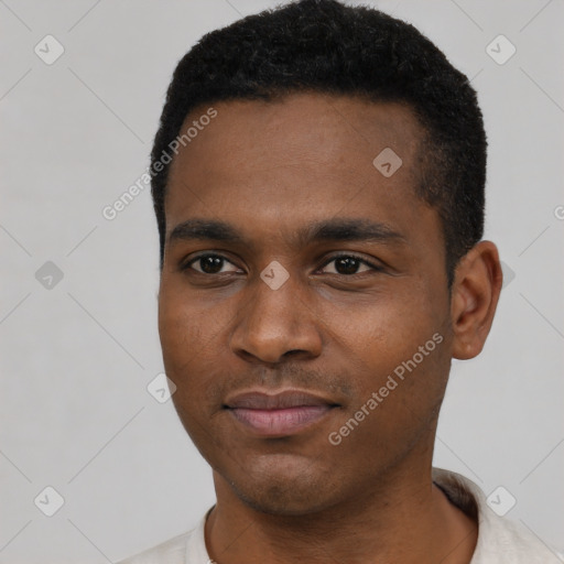 Joyful black young-adult male with short  black hair and brown eyes