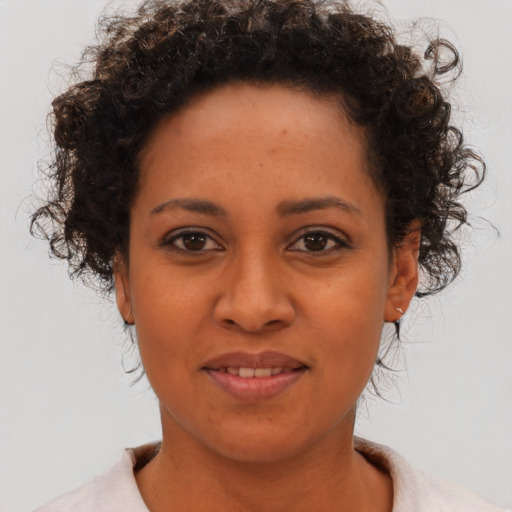 Joyful black young-adult female with short  brown hair and brown eyes
