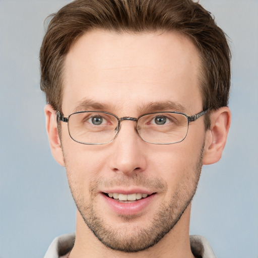 Joyful white adult male with short  brown hair and grey eyes