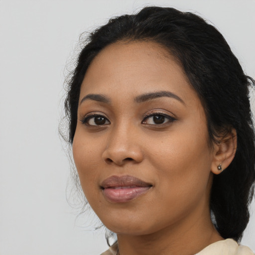 Joyful latino young-adult female with medium  black hair and brown eyes