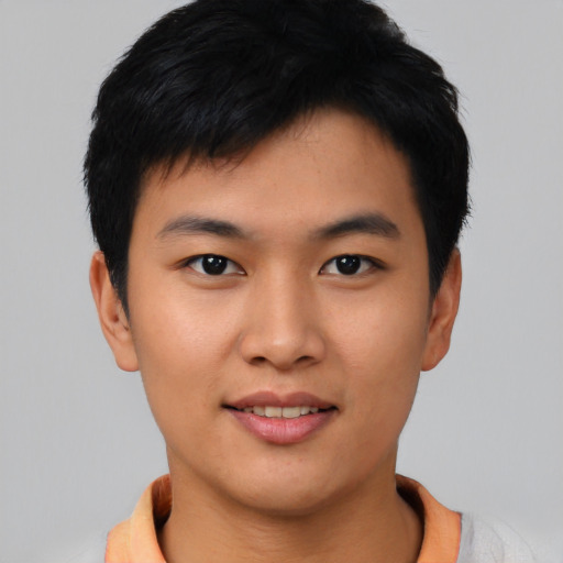 Joyful asian young-adult male with short  black hair and brown eyes