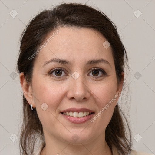 Joyful white adult female with medium  brown hair and brown eyes