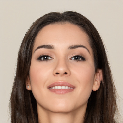 Joyful white young-adult female with long  brown hair and brown eyes