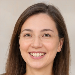 Joyful white adult female with long  brown hair and brown eyes