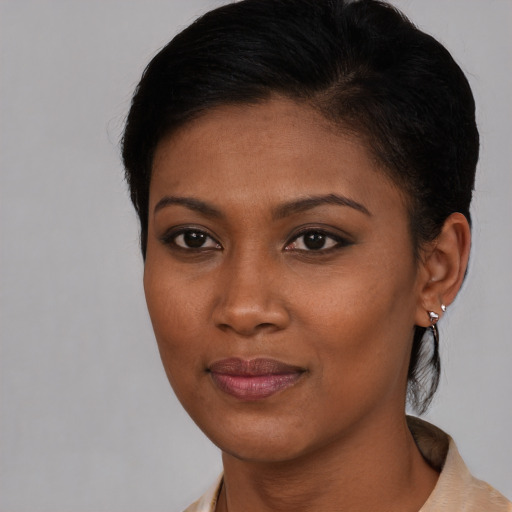 Joyful black young-adult female with short  brown hair and brown eyes