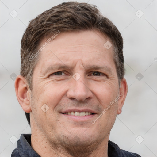 Joyful white adult male with short  brown hair and grey eyes