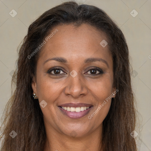 Joyful black adult female with long  brown hair and brown eyes