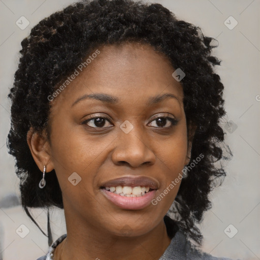 Joyful black young-adult female with long  brown hair and brown eyes